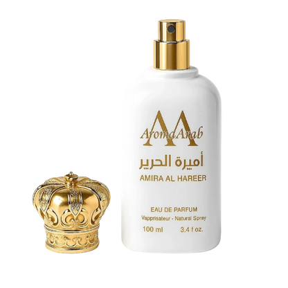 Perfume bottle with gold cap and decorative elements on a white background